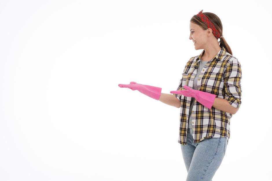 Professional cleaner smiling while inspecting a clean carpet